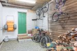 Garage has firewood to use in the fireplace and fire pit, a beach wagon and bikes.